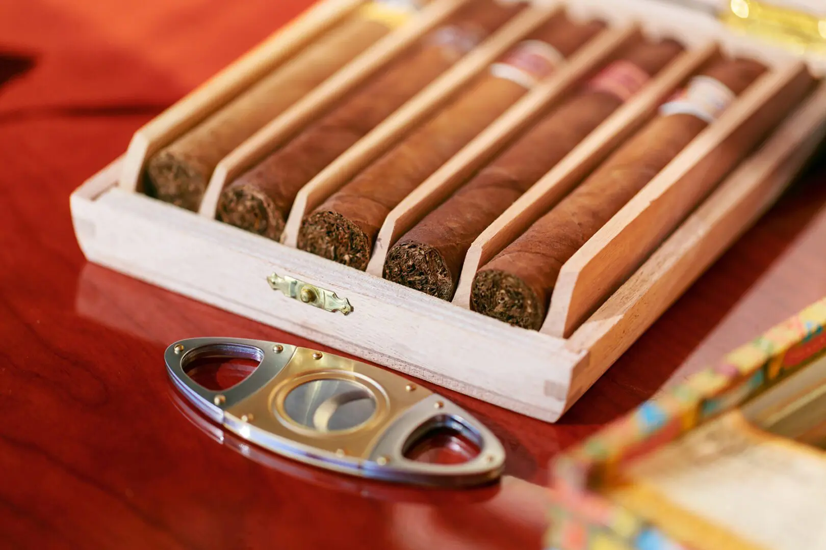 Box of cigars with a cigar cutter.